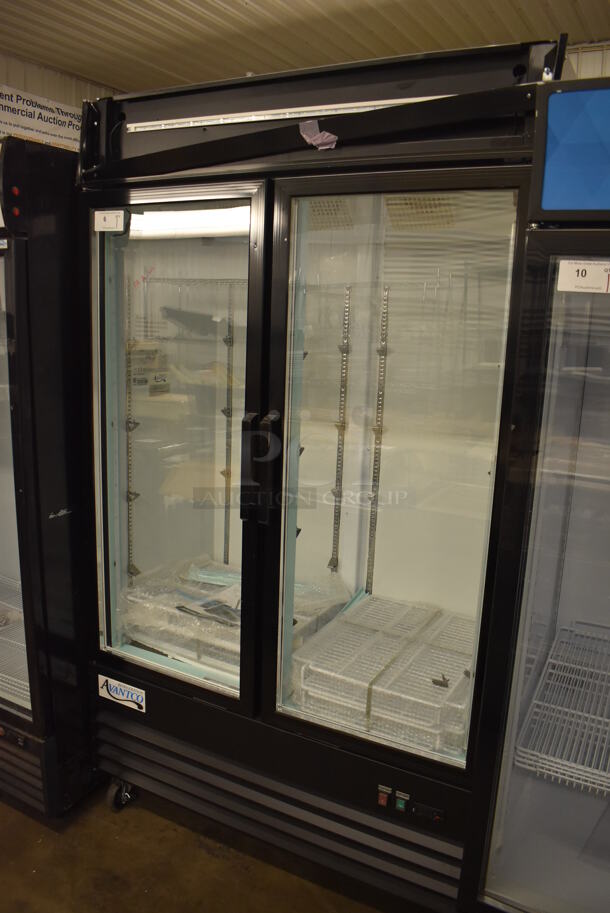 BRAND NEW SCRATCH AND DENT! Avantco 178GDC40HCB Metal Commercial 2 Door Reach In Cooler Merchandiser w/ Poly Coated Racks on Commercial Casters. 115 Volts, 1 Phase. 48x29x85. Tested and Working!