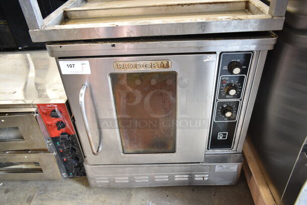 Blodgett Stainless Steel Commercial Natural Gas Powered Half Size Convection Oven w/ View Through Door, Metal Oven Racks, Thermostatic Controls and Equipment Stand on Commercial Casters. Missing 1 Caster. - Image 1 of 11