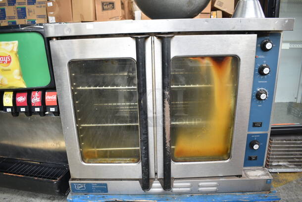 Duke Stainless Steel Commercial Natural Gas Powered Full Size Convection Oven w/ View Through Doors, Metal Oven Racks and Thermostatic Controls.  - Image 1 of 5