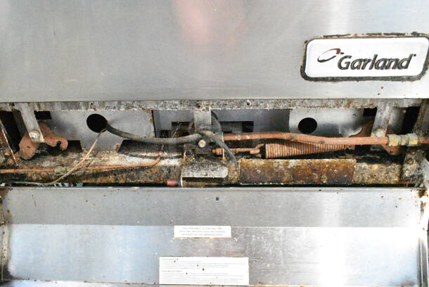 Garland M44T Stainless Steel Commercial Natural Gas Powered Flat Top w/ Oven, Salamander Cheese Melter and Back Splash on Commercial Casters. - Image 10 of 12