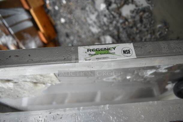 BRAND NEW SCRATCH AND DENT! Regency 600UPR8WTELS 8 Pan End Load Aluminum Undercounter Bun / Sheet Pan Rack with Stainless Steel Top. 2 Casters Need To Be Attached.  - Image 7 of 7