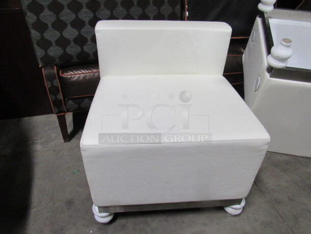 One White Pleather Modern Look Side Chair With Cushioned Seat And Back.