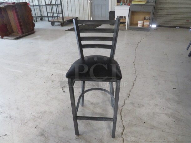 Metal Bar Height Chair With Footrest And A Black Cushioned Seat. 4XBID - Image 1 of 2