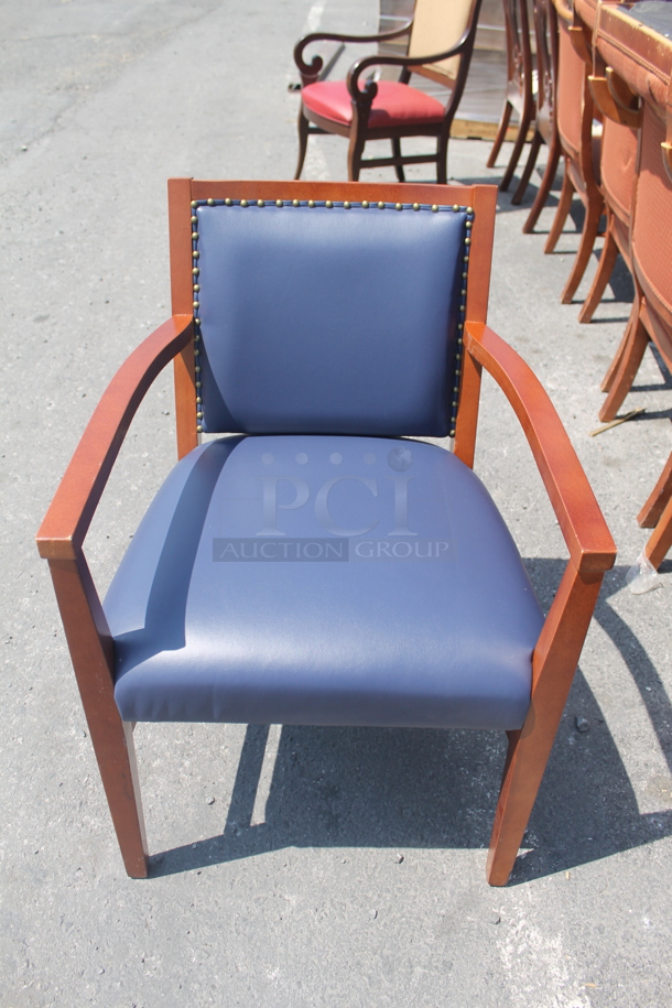 16 Wood Chairs With Blue Vinyl Back Cushion With Nailhead Detail And Vinyl Seat Cushions. 16 Times Your Bid! Cosmetic Condition May Vary. 