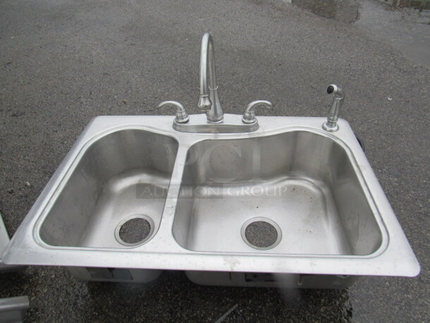 One KOHLER Stainless Steel 2 Well Drop In Sink With Faucet And Hose Sprayer. 33X22X8.5 - Image 1 of 1