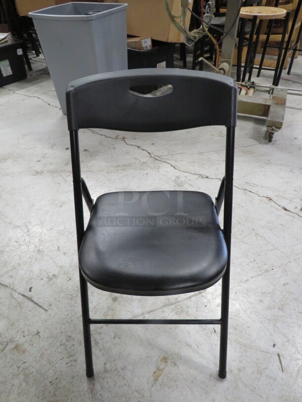 Black Poly Folding Chair With A Black Cushioned Seat. 5XBID - Image 1 of 1