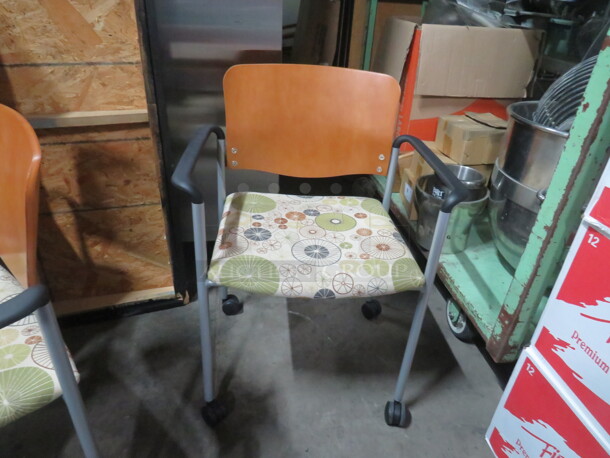 NEW Metal Arm Chair With Wooden Back, And Cushioned Seat On Casters. 2XBID