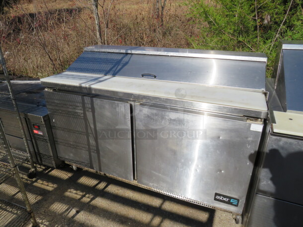 One 2 Door Asber Refrigerated Prep Table With 2 Racks, And
Cutting Board On Casters. Model# APTS-60-16. 115 Volt. 60X31X42